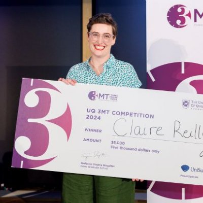 An award recipient holding up a large cheque